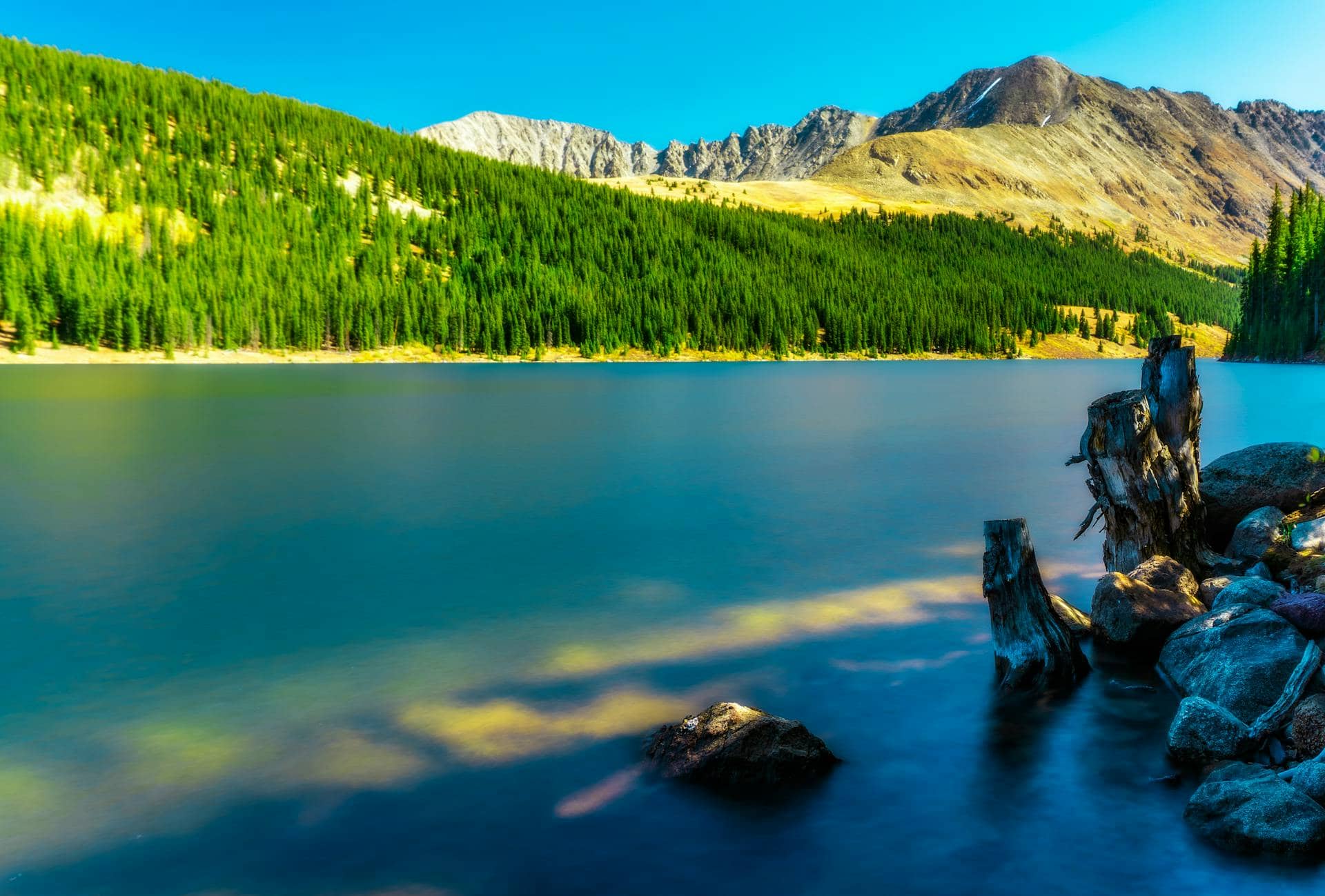 Alpine lake reflecting Colorado mountains