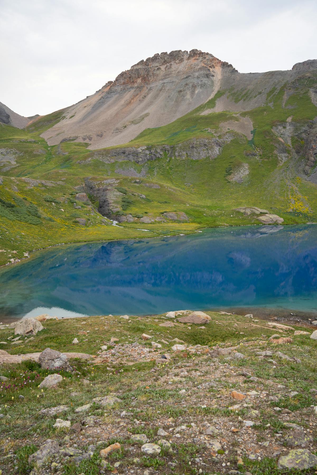 Vibrant blue alpine lake surrounded by Colorado mountain scenery