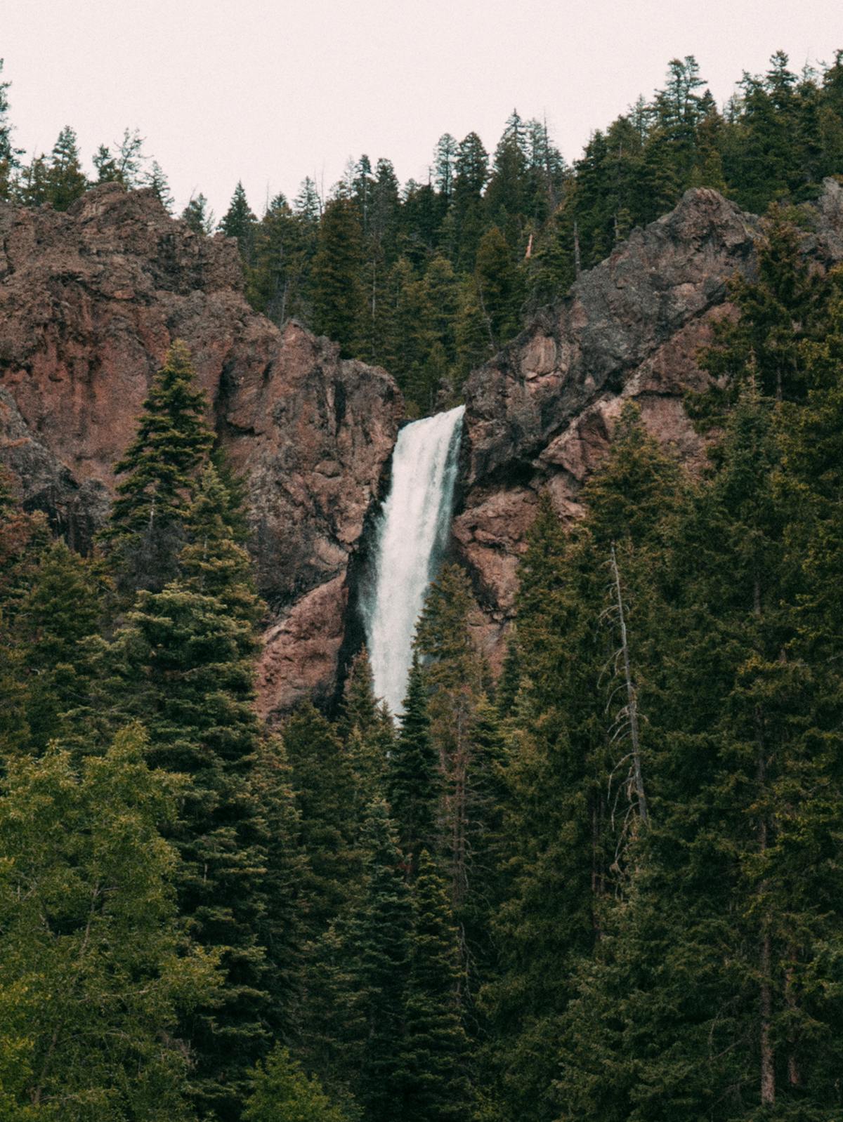 Waterfall cascading over rocks in a forested Colorado setting